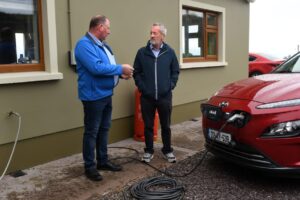 Seán Kelly with Dinny Galvin as his car recharges near Lispole, Co. Kerry