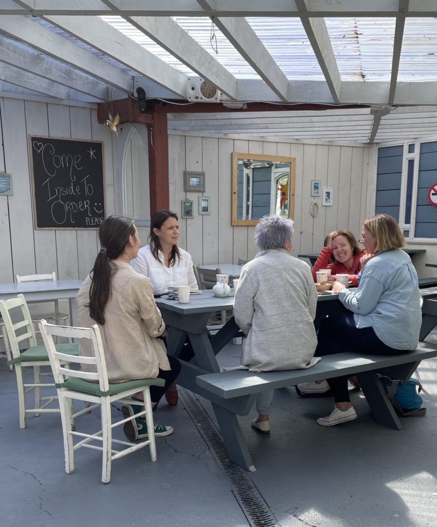 Five people having a discussion in an outdoor café