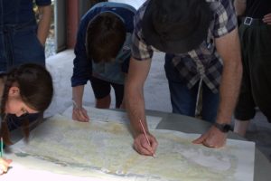 Several people working over a map