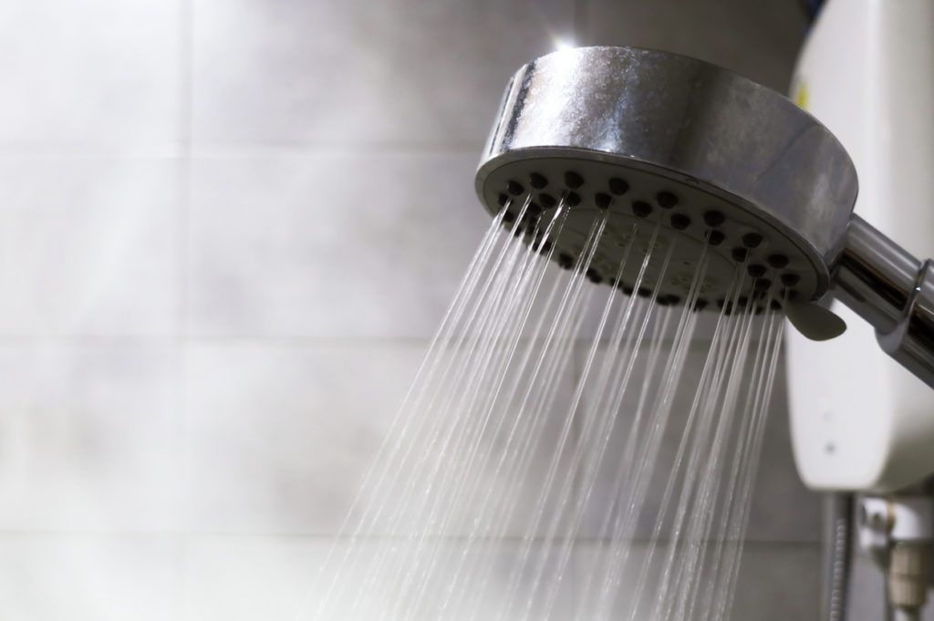 Shows water and steam coming from a shower head